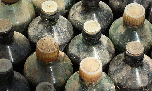 Why You Should Bury Glass Bottles In Your Garden